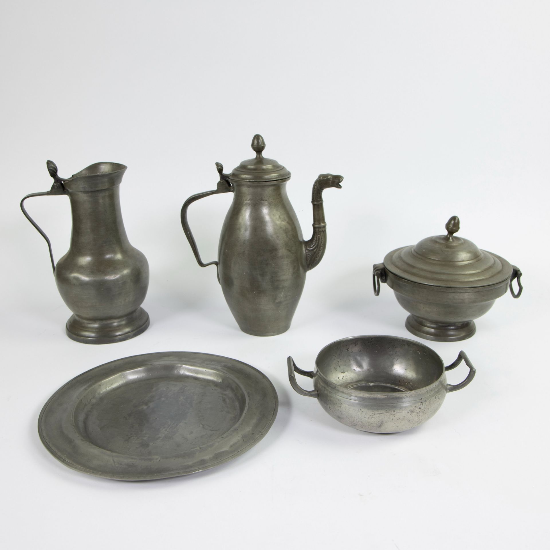 A collection of old tin items a.o. a jug, coffee pot, lid pot, pot and saucer