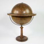 French papier-mâché library globe with wooden bow on central wooden leg.