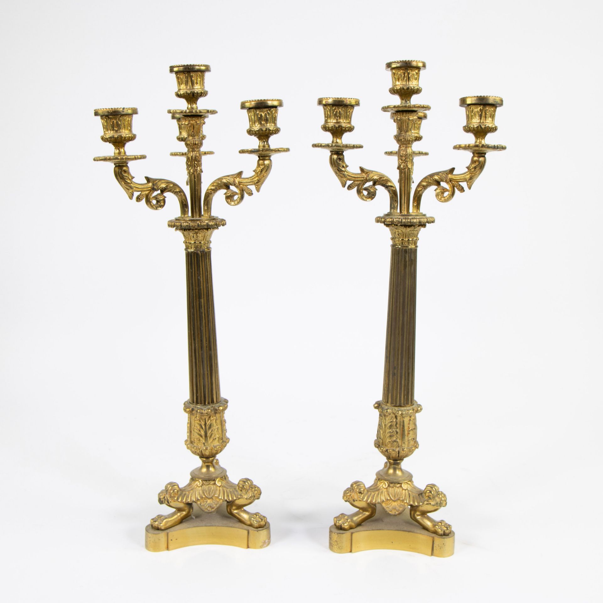 A pair of gilt bronze candlesticks with four light points and on three lion's feet. - Image 3 of 3