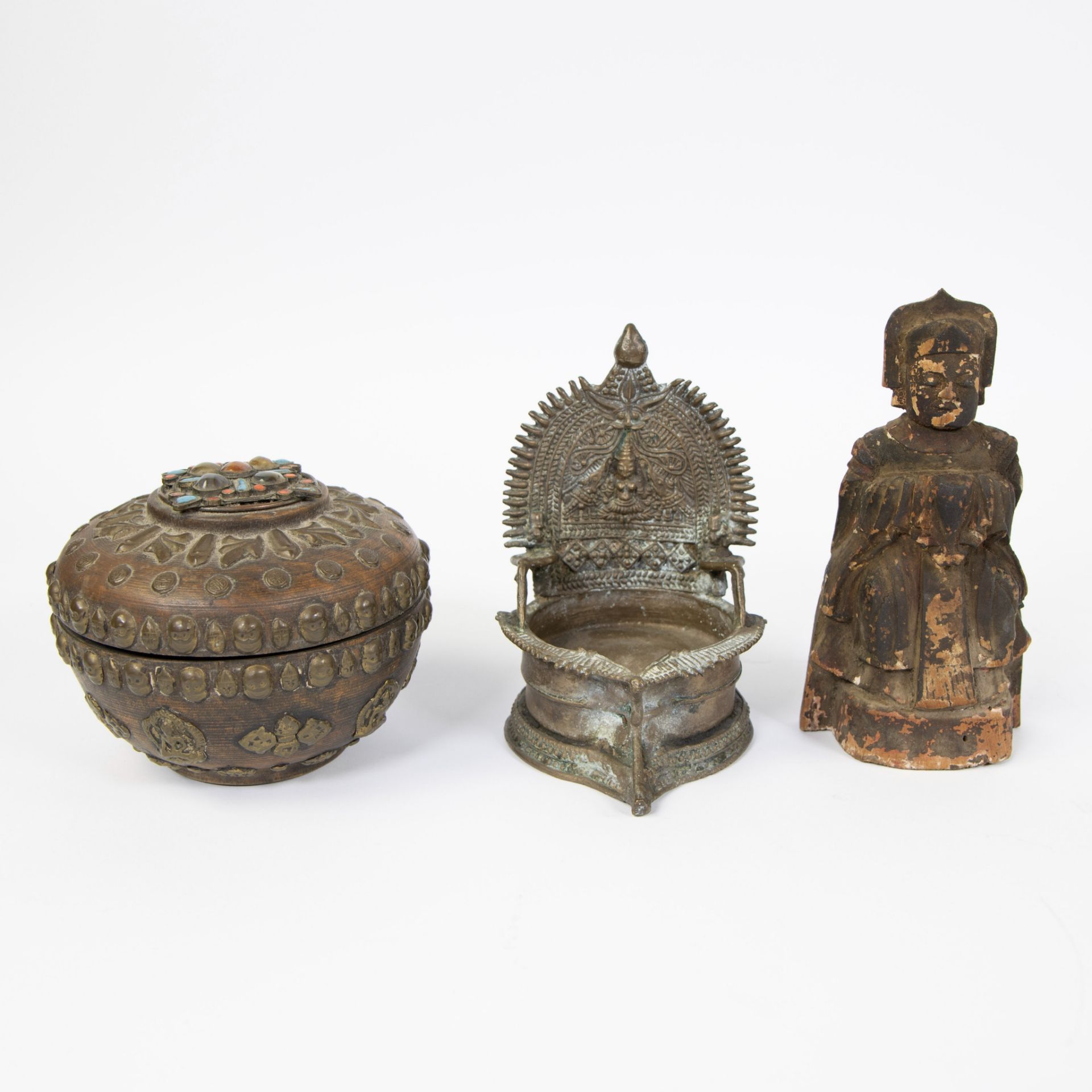 Collection of Tibetan, offering pot inlaid with stones and skulls, bronze oil lamp and wooden Buddha