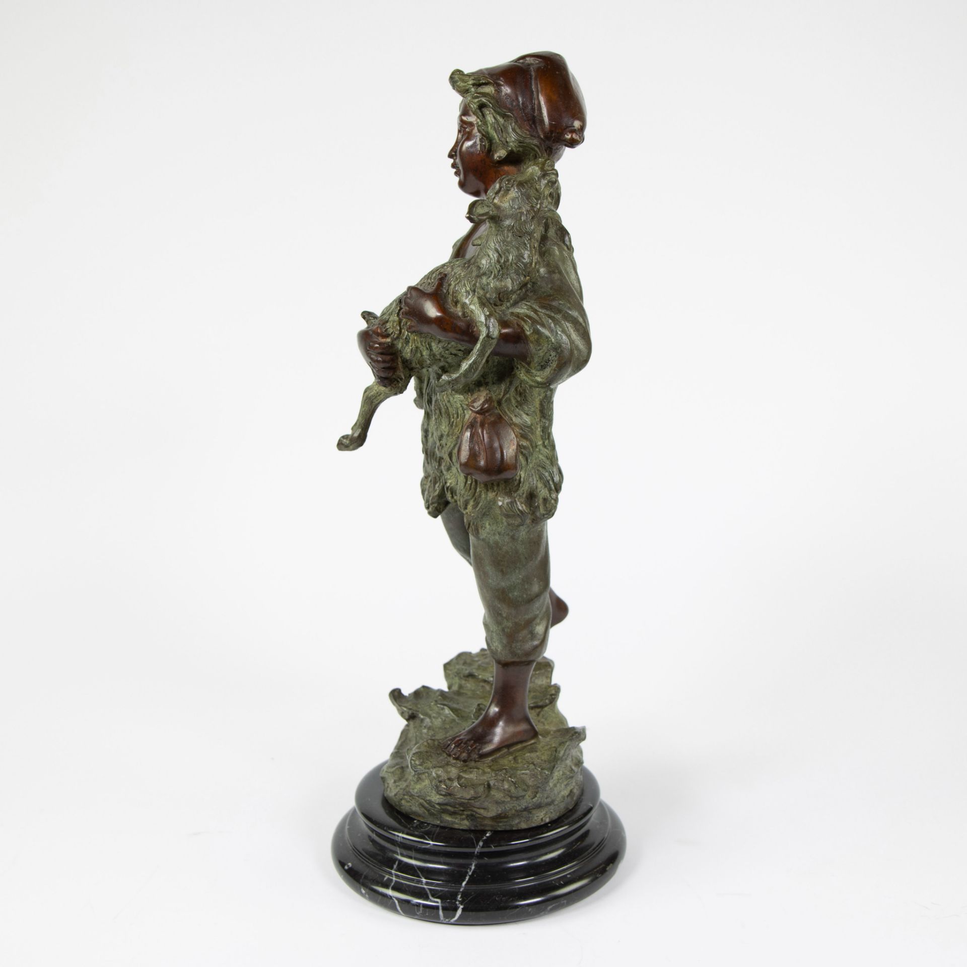 Brown and green patinated bronze statuette of a boy with a goat on a marble base - Image 2 of 4