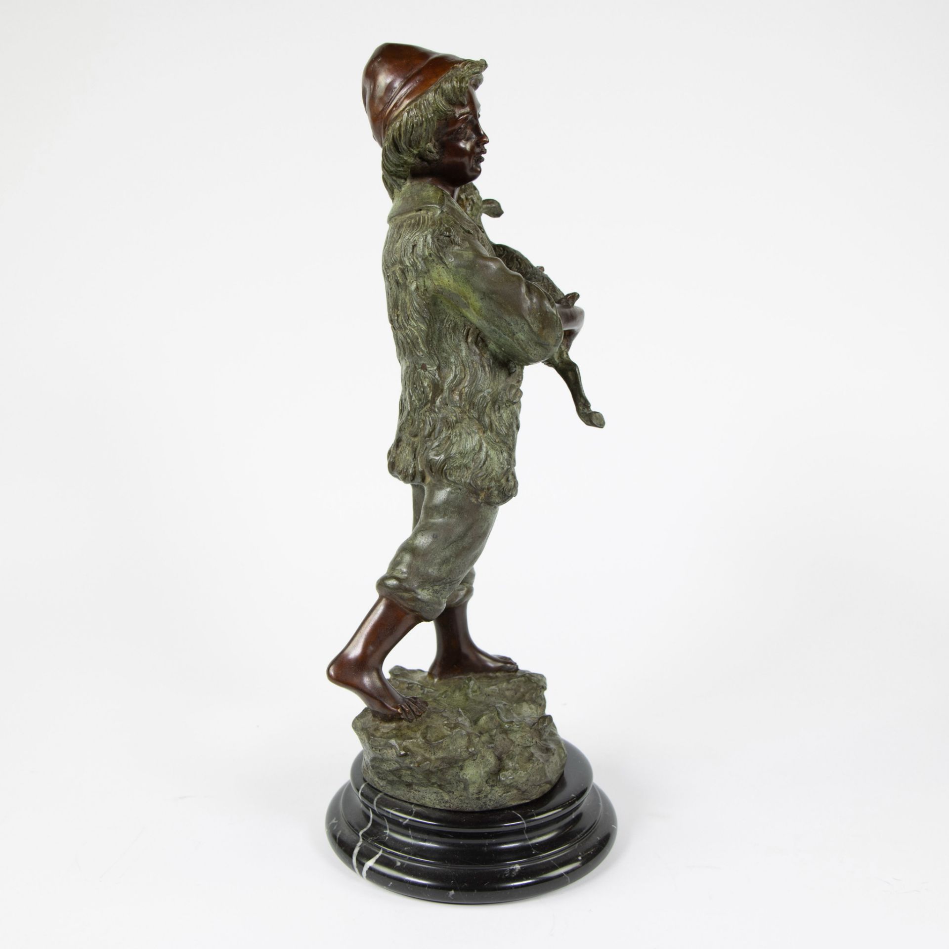 Brown and green patinated bronze statuette of a boy with a goat on a marble base - Image 4 of 4