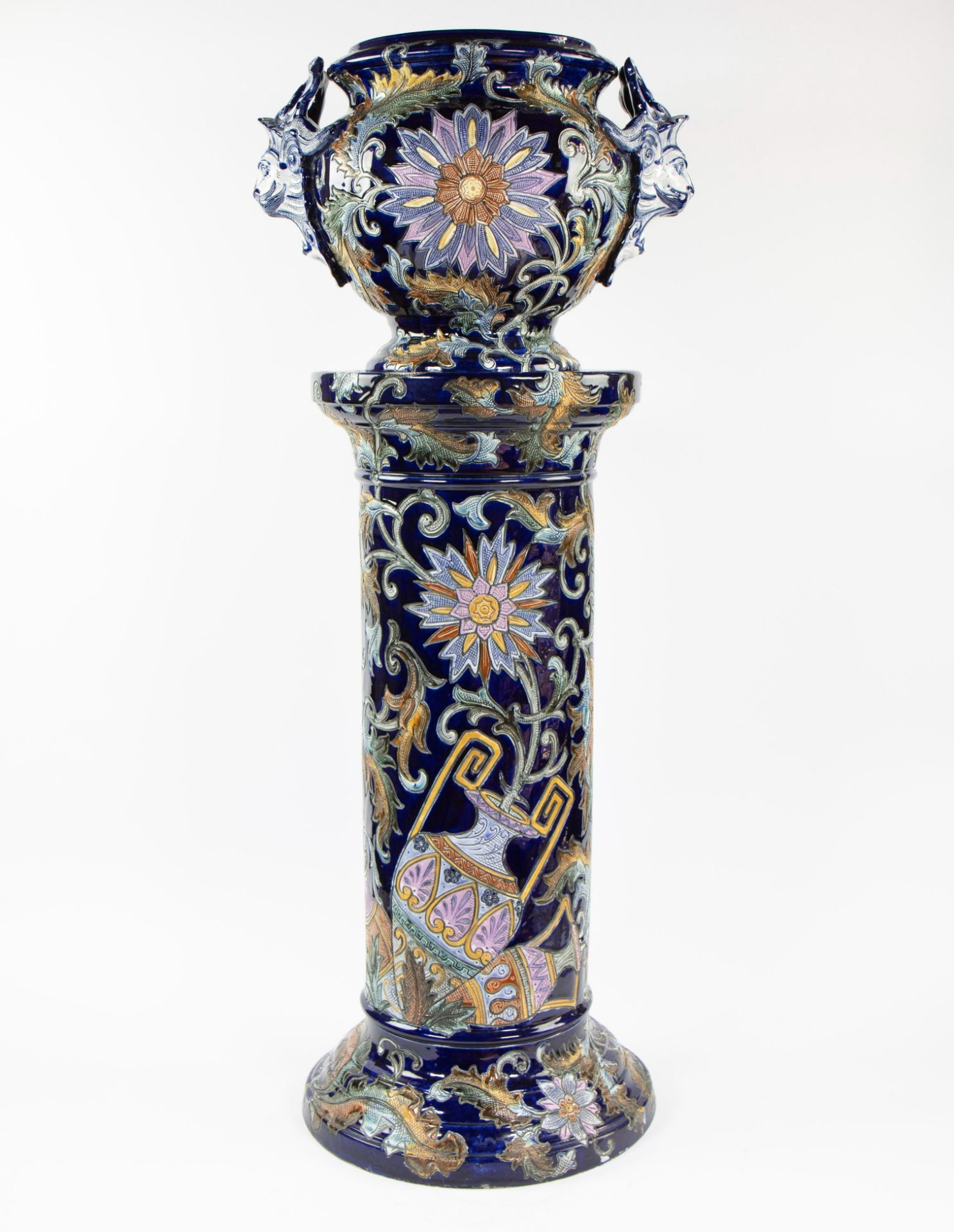 Beautiful two-piece glazed ceramic plant stand decorated with satyrs and floral motifs, circa 1900.