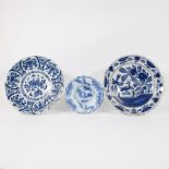 A Delft blue and white gadrooned chinoiserie dish, 17th C and 2 blue and white plates.