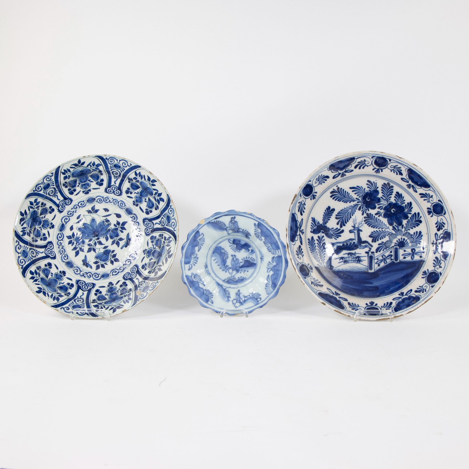 A Delft blue and white gadrooned chinoiserie dish, 17th C and 2 blue and white plates.