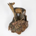 Wooden sculpture of a roe deer on a rock, German