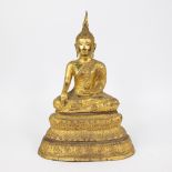 A gilded statue of Buddha seated in lotus position, Thailand