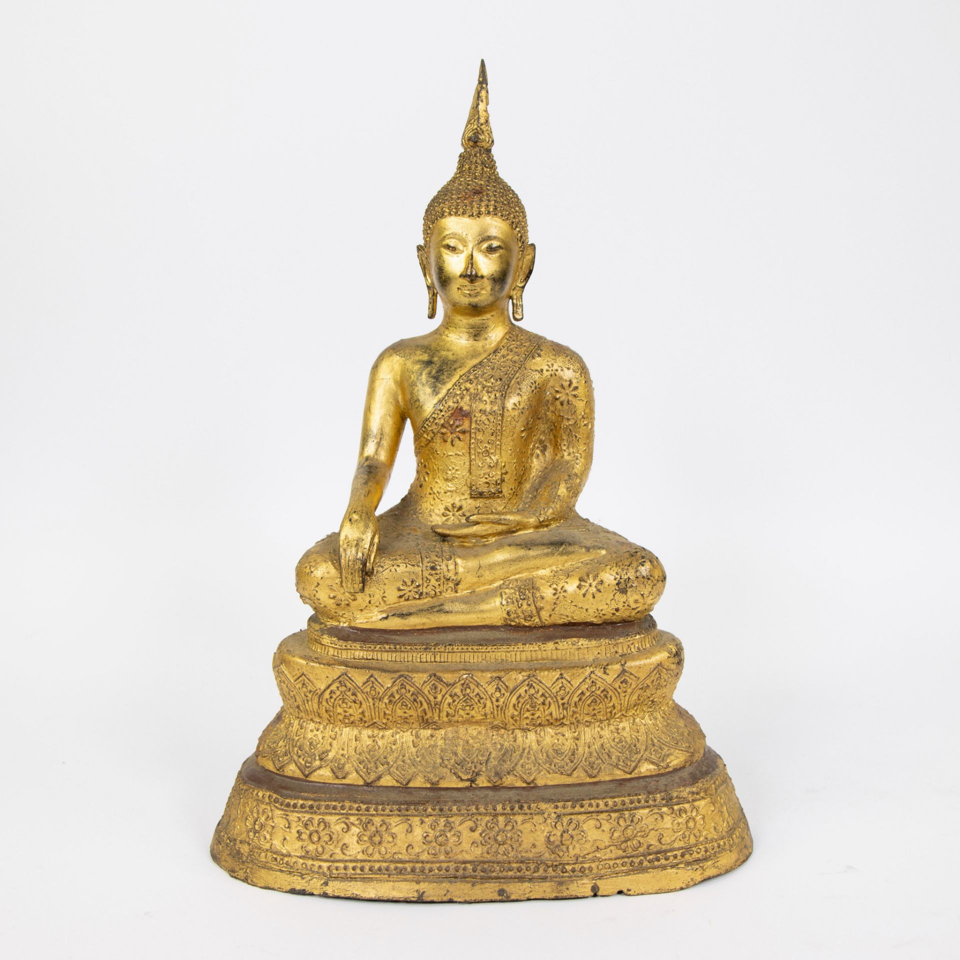 A gilded statue of Buddha seated in lotus position, Thailand