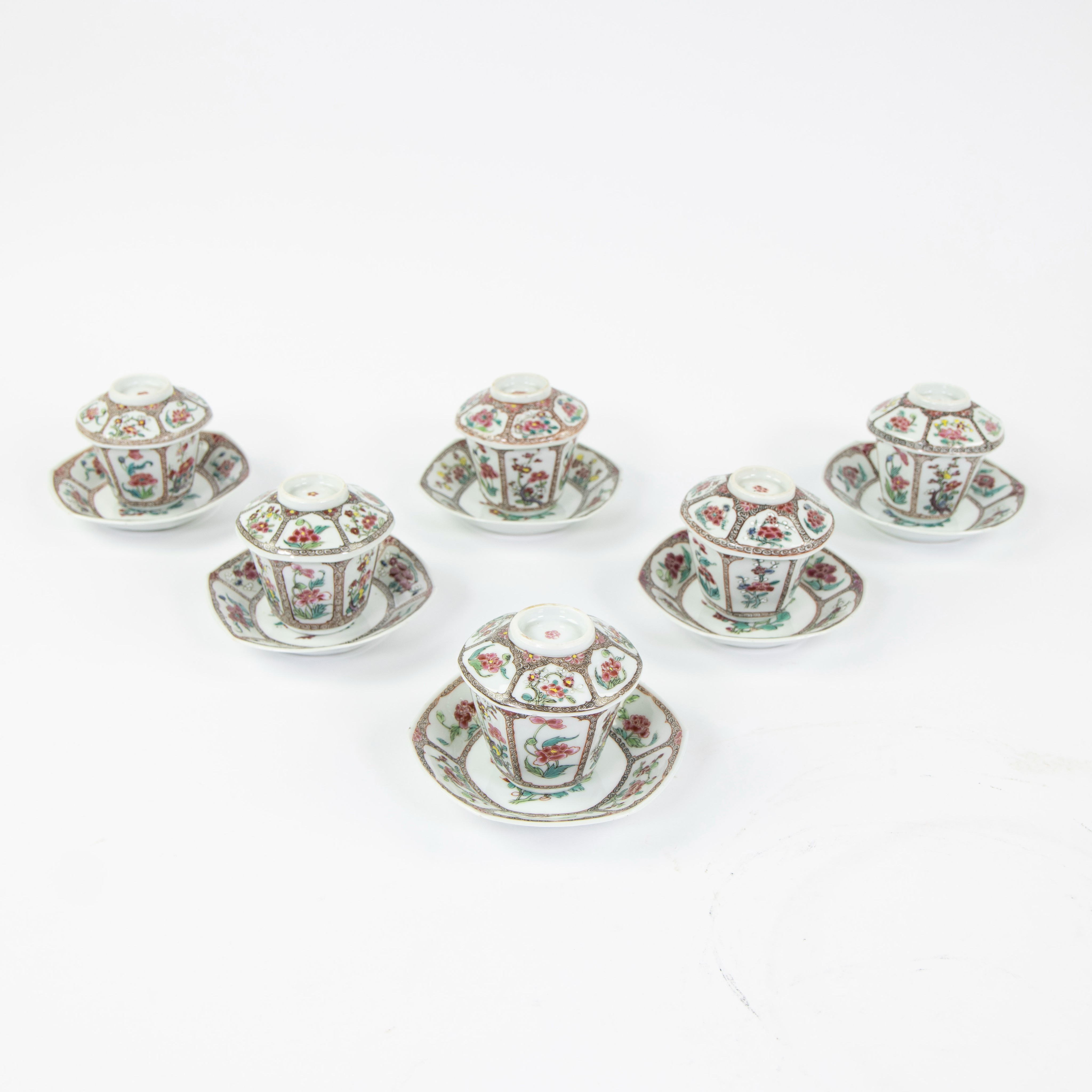 Set of six famille rose cups with their saucers and covers, decorated with flowers and blossom withi