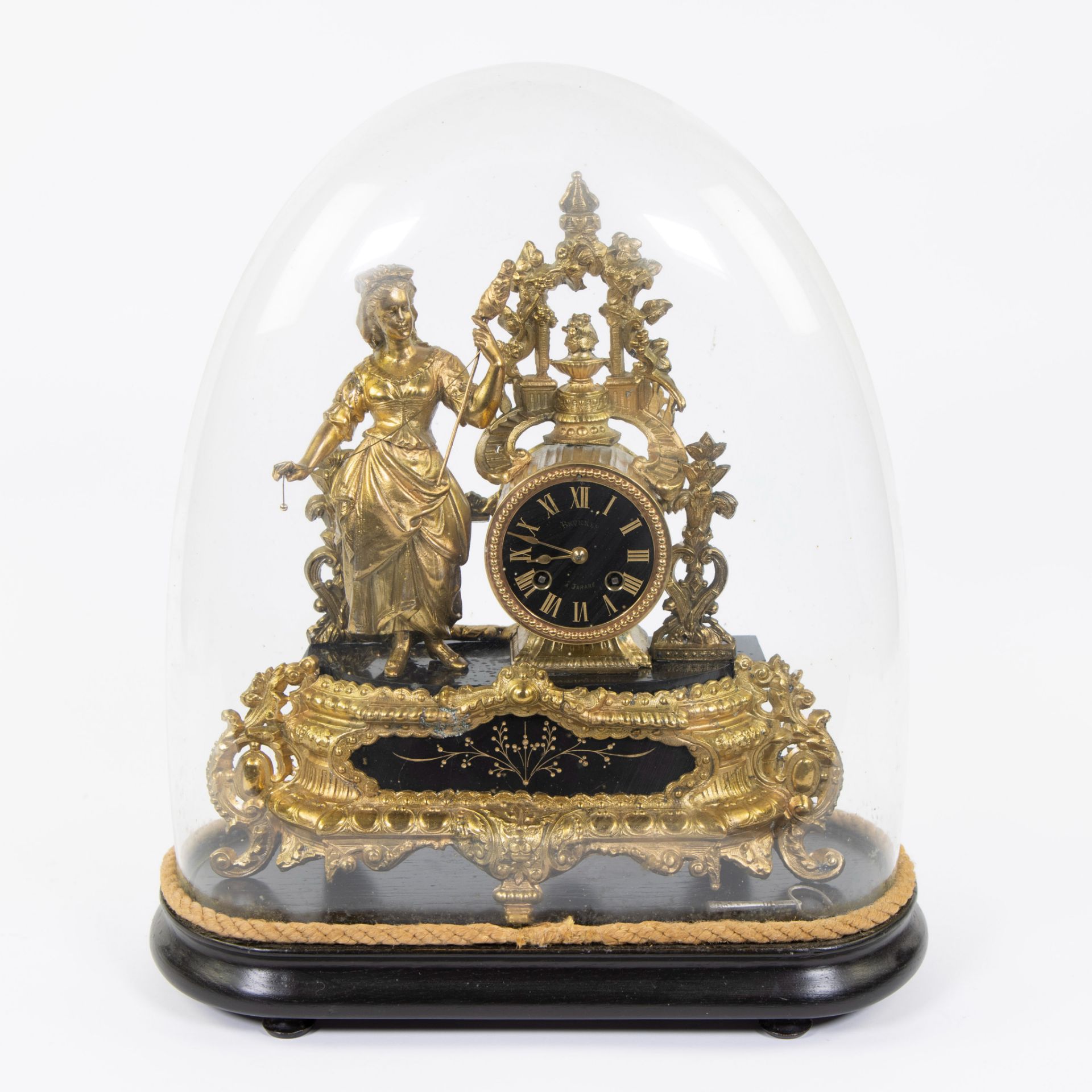 Gilded mantel clock under bell jar depicting an elegant lady, marked on the dial Brunnee à Tarare