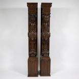 2 wooden support pillars decorated with mythical creatures, lions and lion claws