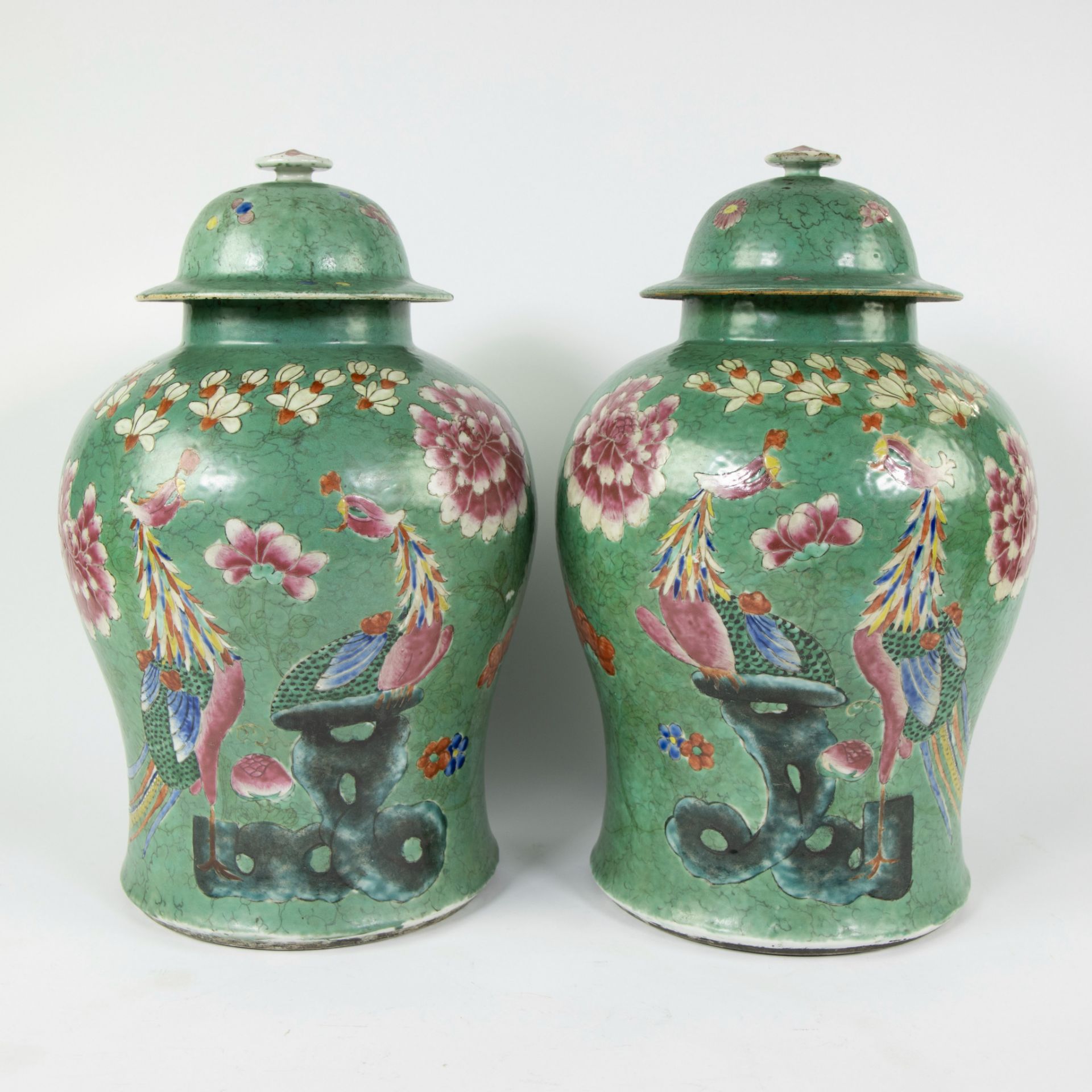 Pair of Chinese baluster shaped jars and their covers symmetrically decorated in fencai enamels depi