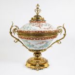 Imposing porcelain tureen/table piece on a fire-gilt base, decorated with colorful floral motifs and