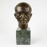 Bronze bust of a gentleman on a marble base, signed De Wee.