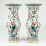 Pair of symmetricallly painted Chinese porcelain Gu vases decorated in famille rose enamels with roo