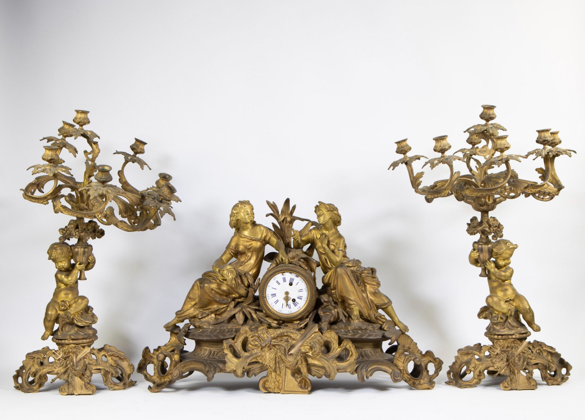 An impressive three-part-piece gilded Louis XV clock from famous French clockmaker Guiche Palais Roy