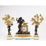 A three-piece Louis XVI clock set in gilt and dark patinated bronze and white marble. The mantel clo