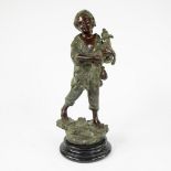 Brown and green patinated bronze statuette of a boy with a goat on a marble base
