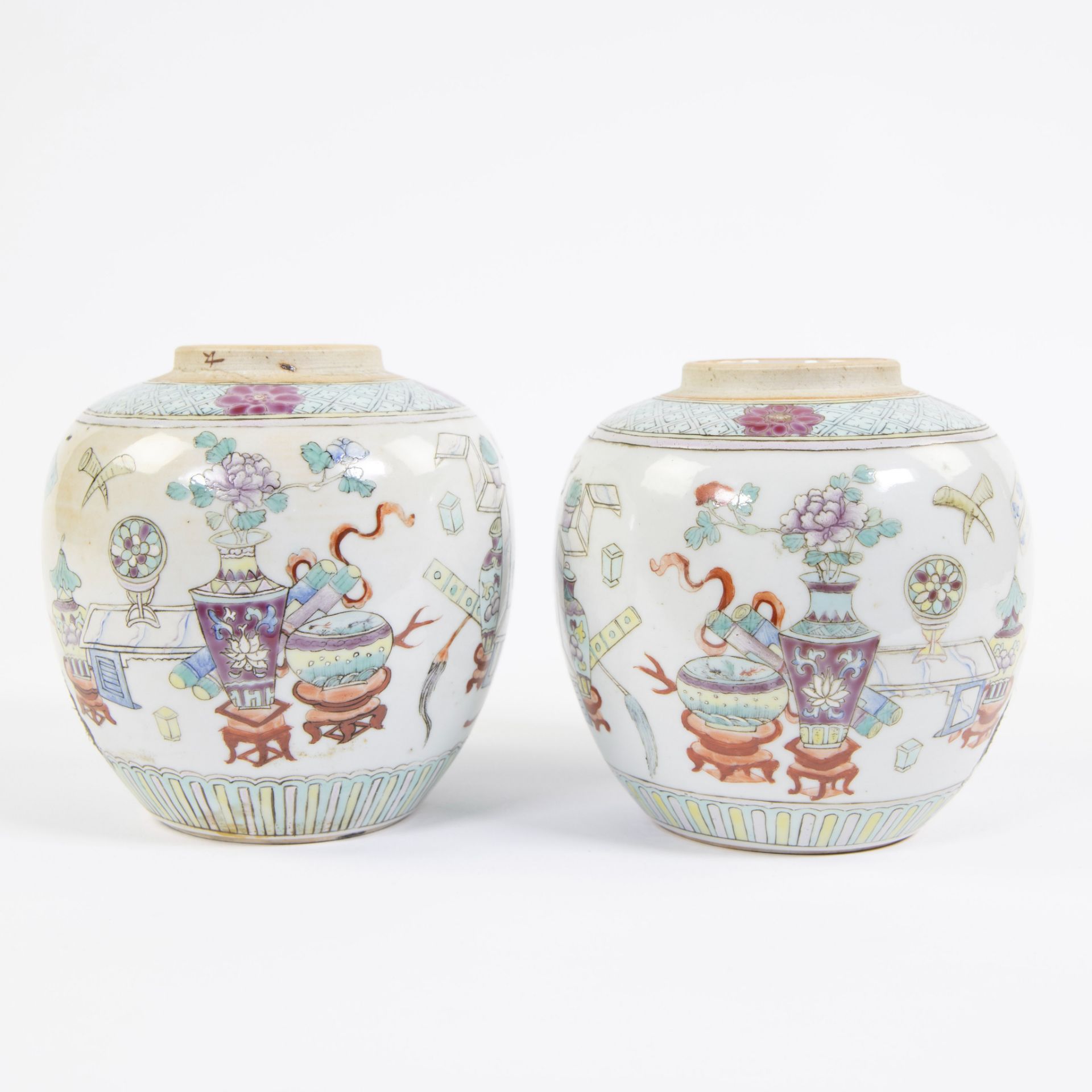 Two porcelain jars, decorated in famille rose enamels with prcious objects and auspicious symbols. M