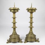 Pair of neo-gothic 19th century candlesticks, at the bottom are 3 dogs