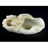 A PALE CELADON JADE AND RUSSET LOTUS BRUSH WASHER l. 13 cm