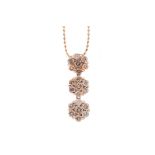 A ROSE GOLD DIAMOND FLOWER CLUSTER PENDANT