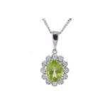 A PERIDOT AND DIAMOND CLUSTER PENDANT