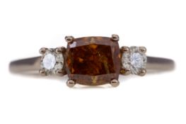 A FANCY YELLOWISH ORANGE DIAMOND THREE STONE RING