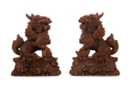 A PAIR OF CHINESE CARVED BOXWOOD FOO DOGS