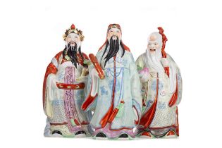 THREE CHINESE FAMILLE ROSE IMMORTAL FIGURES