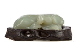 A CHINESE CELADON JADE CARVING OF A BUFFALO CALF