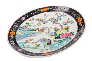 AN EARLY 20TH CENTURY CHINESE FAMILLE NOIRE CIRCULAR PLAQUE