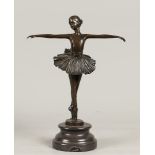 A brown patinated bronze statuette of a balerina on pointe