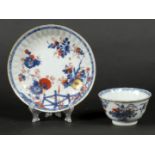 A porcelain Imari cup and saucer with relief decoration and