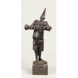 A bronze sculpture of an accordion playing clown. 2nd half