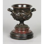 A cast bronze casolette on a marble base. ca. 1880. H.: 19