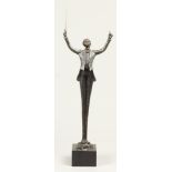 A 20th century bronze statuette of a conductor. H.: 48 cm.