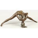 An erotic figurine of a young woman in Yoga pose. H.: 12 cm