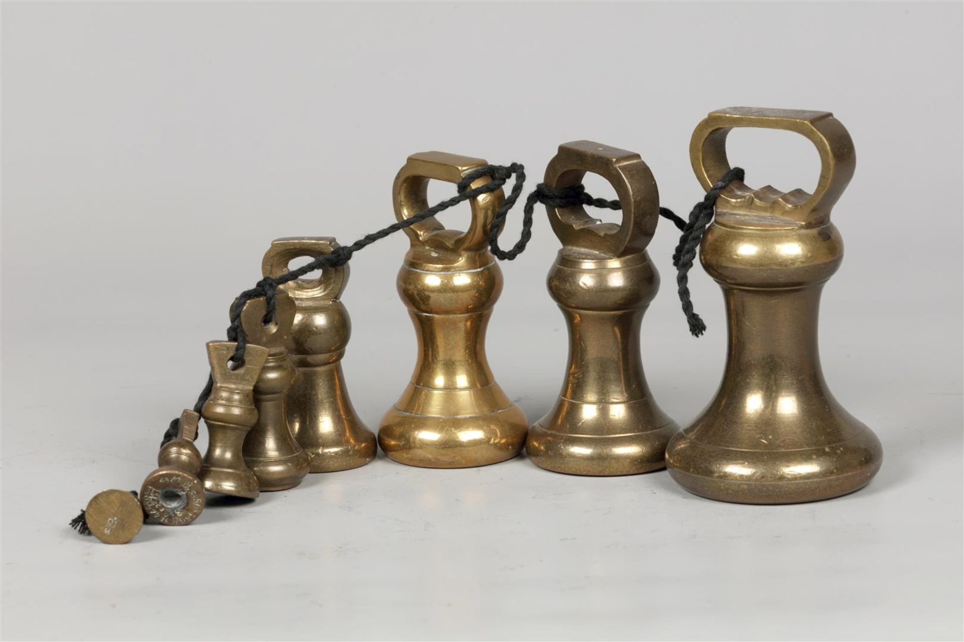 A set of clock weights. England, circa 1900.