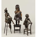 A lot consisting of (3) bronze sculptures of a.o. a child o