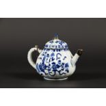 A porcelain ribbed teapot with floral decor, with silver mo