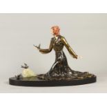 A cold-painted ZAMAC sculpture of a lady with birds on a ho