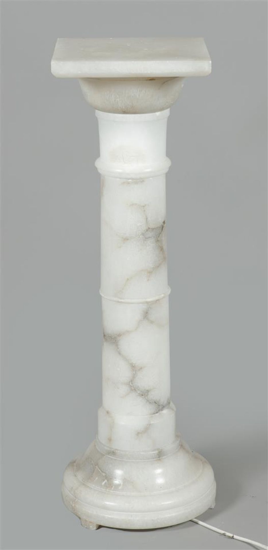 A white marble column / column, built from separate parts. 