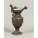 A cast pewter vase with putto and dragon head as spout. H.: