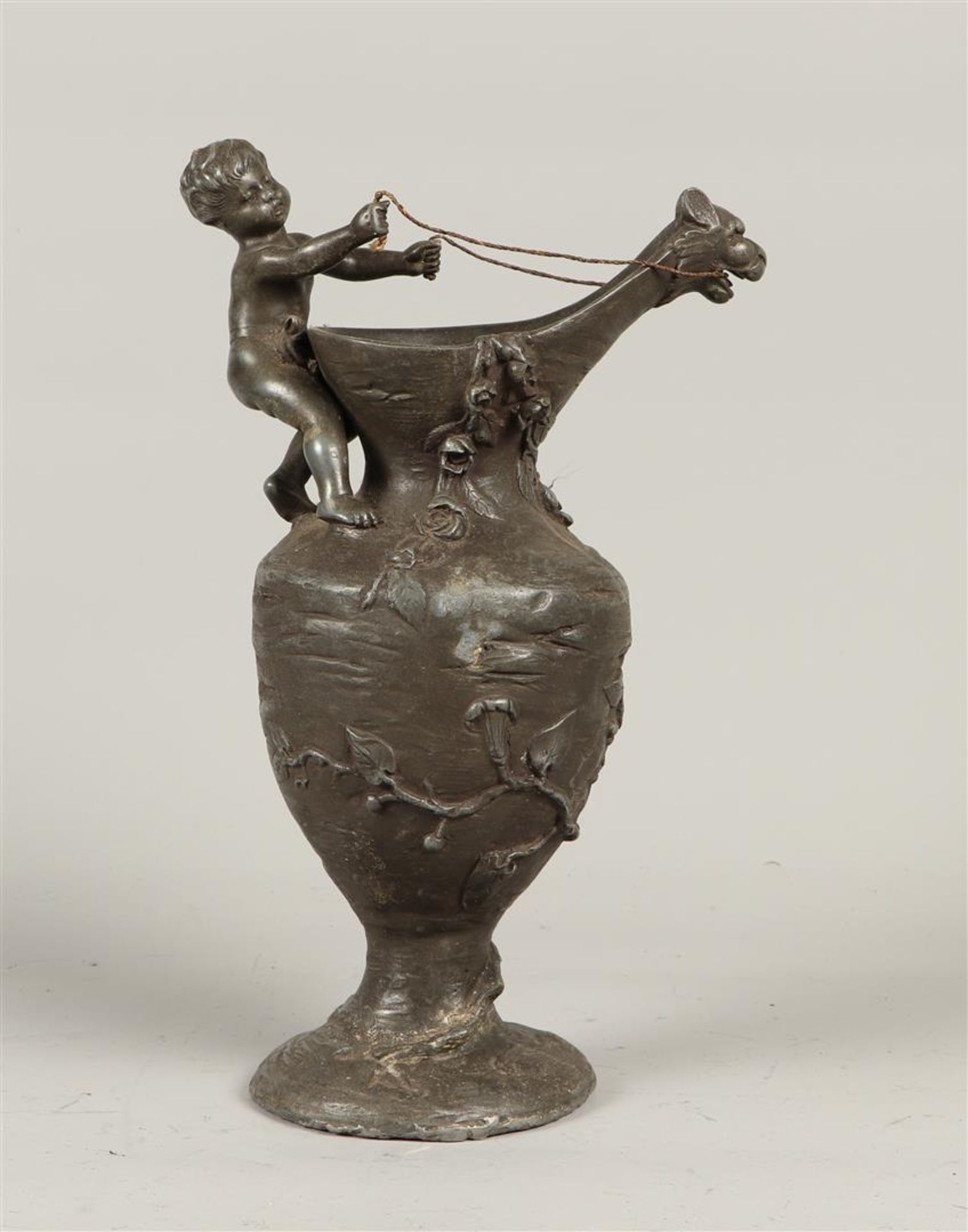 A cast pewter vase with putto and dragon head as spout.
H.: