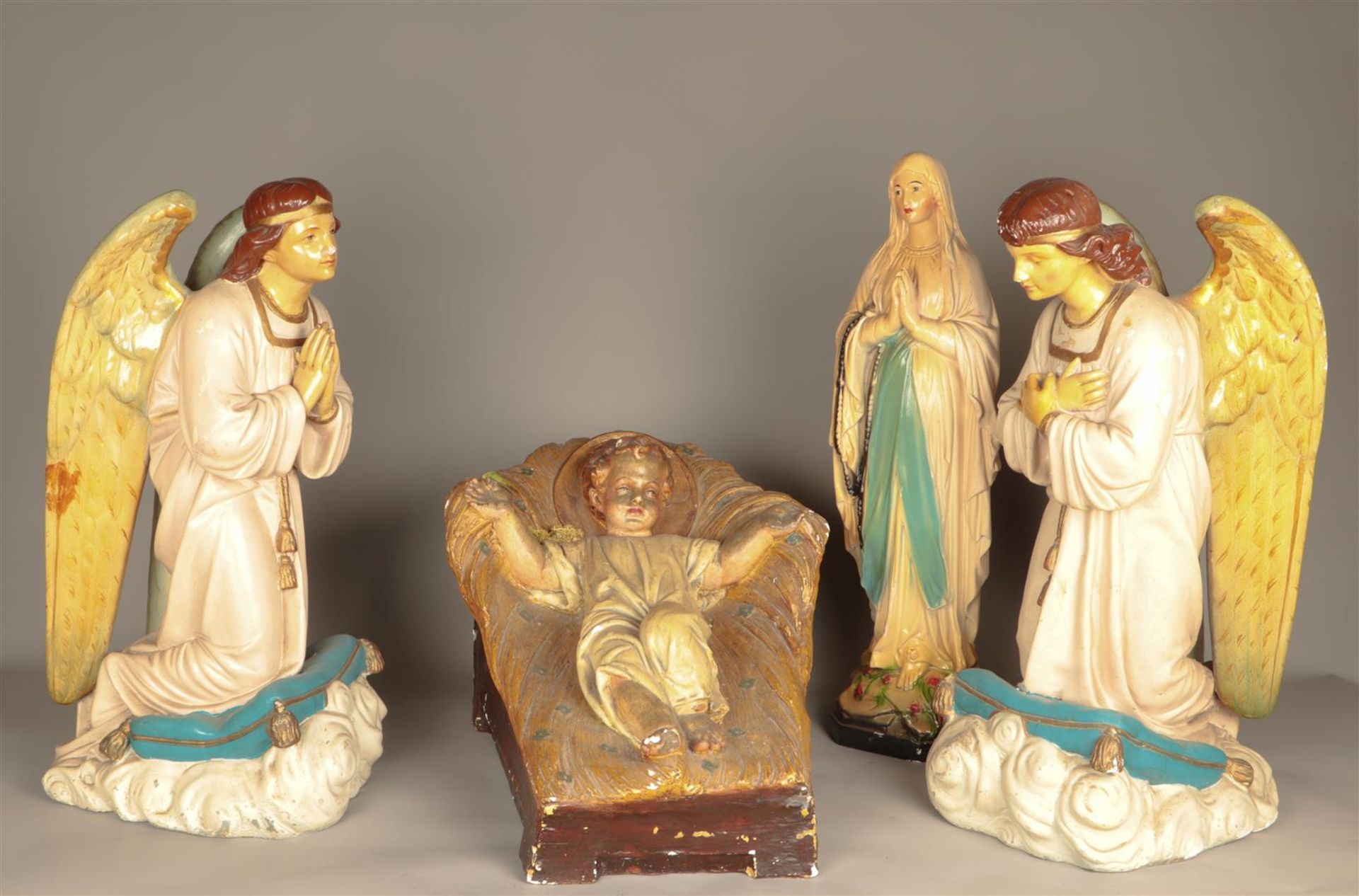 A polychrome plaster group of the Savior in the manger and 