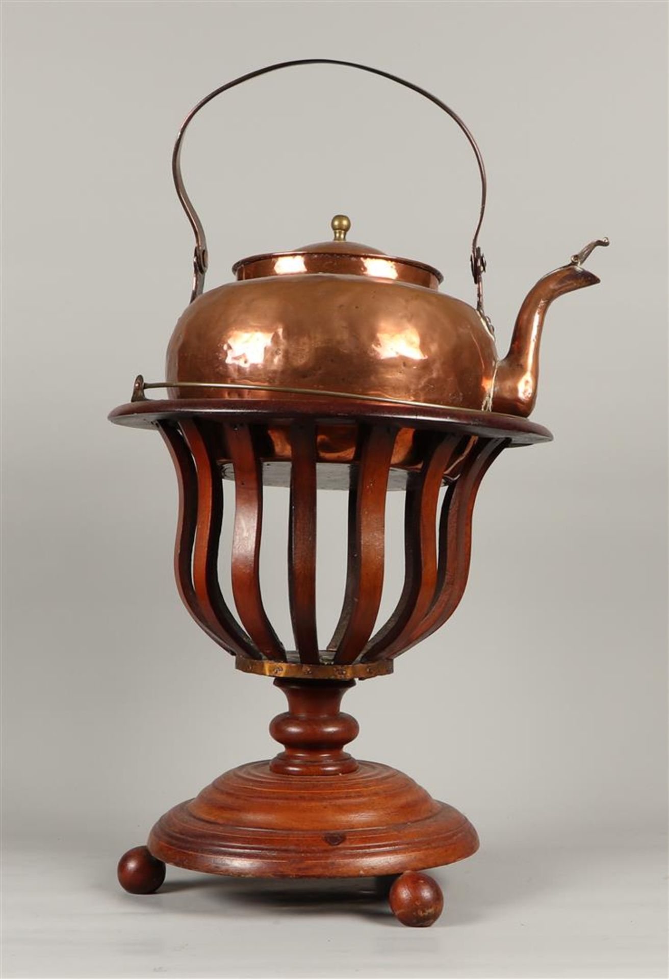 A mahogany tea stove with a copper kettle. ca 1900.