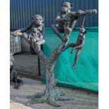 A large bronze garden statue depicting three chimps sitting
