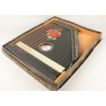 A guitar Zither including tuning key and original box.