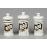 A set of porcelain apothecary jars with floral decor. Frank